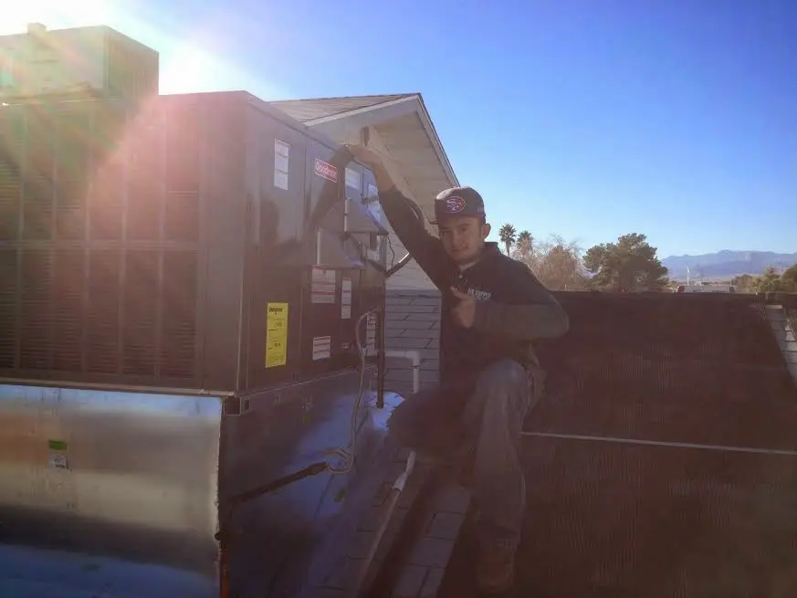 HVAC technician performing Boiler Repair on a rooftop unit in Greenbelt